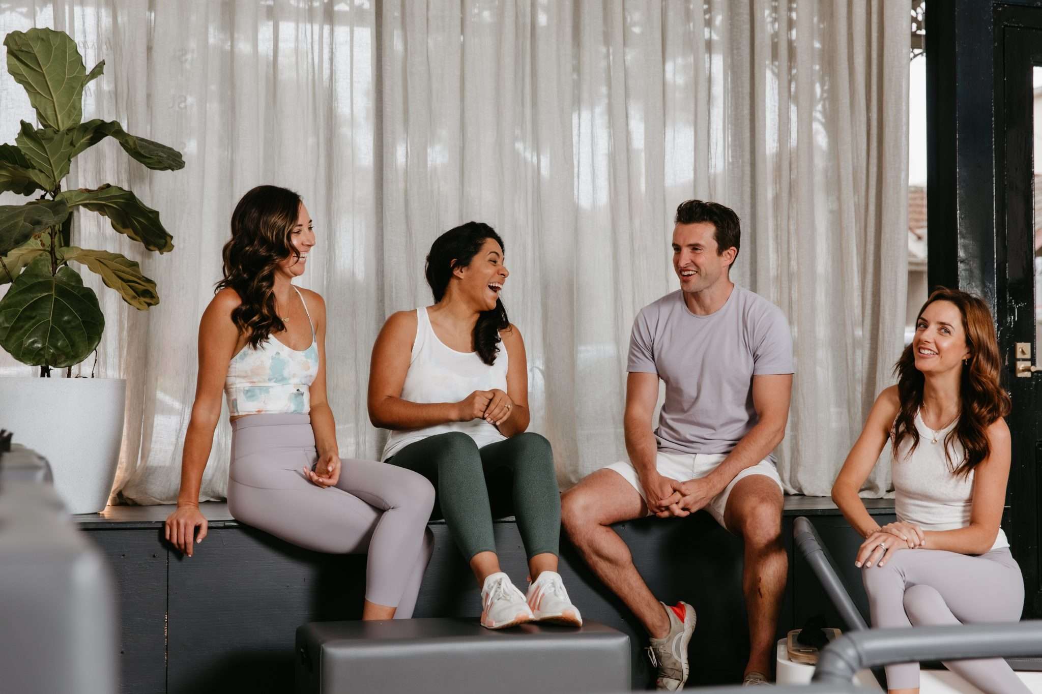 The four physiotherapist directors of Sum Of Us Studio laughing together